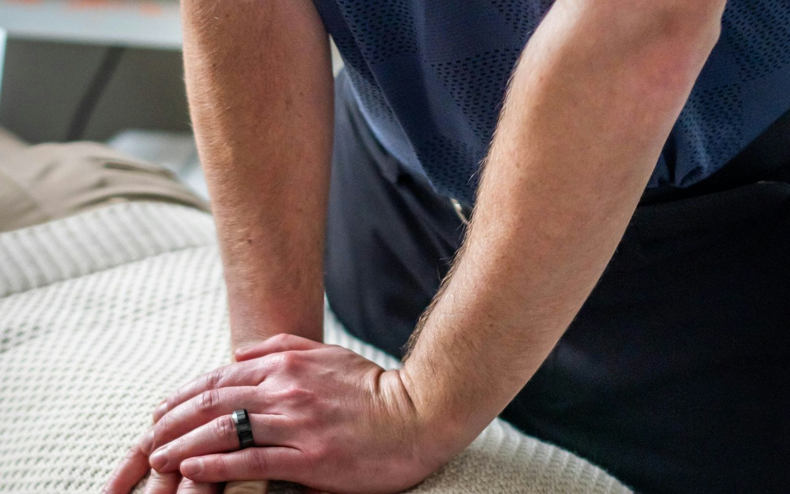 A chiropractor's hands performing a hands-on spinal treatment