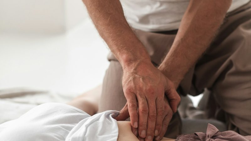 A therapist providing hands-on treatment to a patient