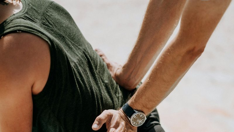 A physiotherapist guiding a patient through a stretching exercise